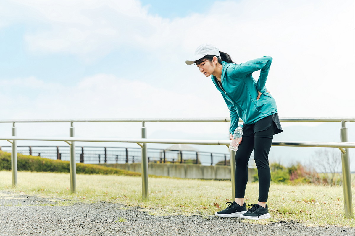 ランニング中に腰の痛みを感じている女性